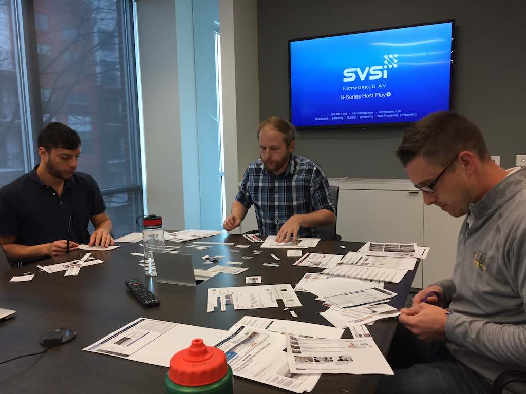 Design and front-end development teams doing a cutout workshop.